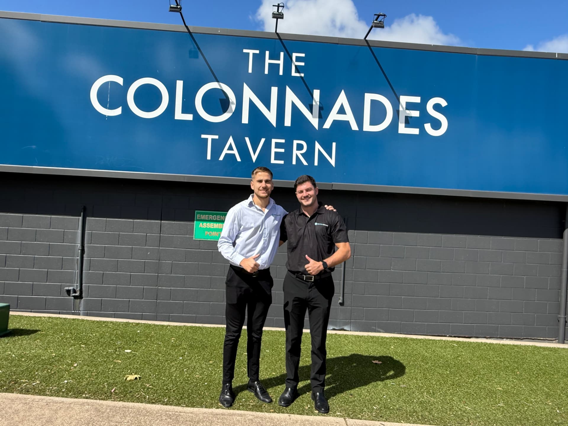 Two New Era team members standing outside The Colonnades Tavern, a hospitality venue serviced by New Era