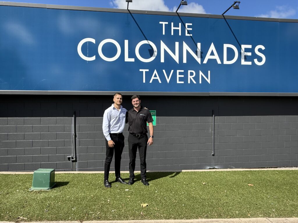 Two New Era representatives standing outside The Colonnades Tavern in South Australia