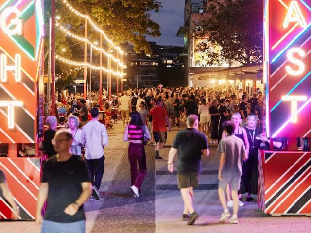 Guests moving through the illuminated Night Feast entry and circulation zone