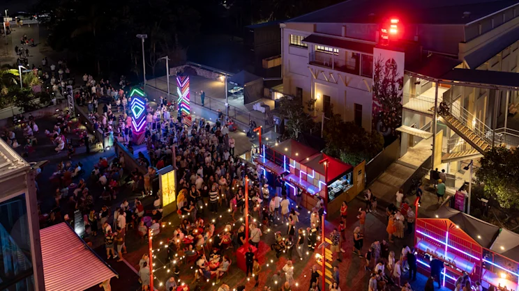 Aerial view of dense crowds moving through the Night Feast site at night
